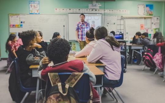 Teacher teaching a class of students